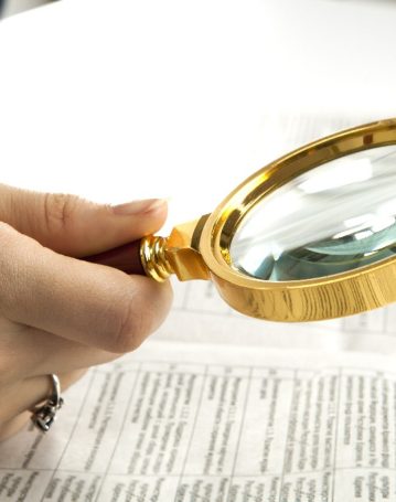 Worker,Examines,A,Magnifying,Glass,Text,Close,Up